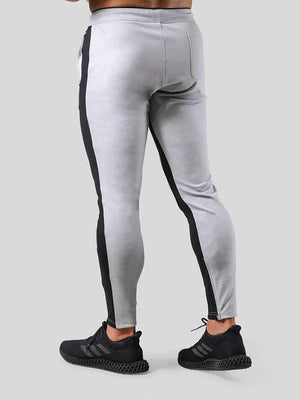 Man wearing ANVTT heather grey side stripe tapered jogger pants