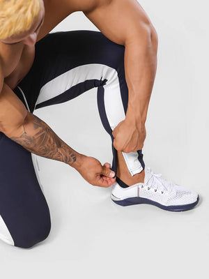 Man wearing ANVTT heather grey side stripe tapered jogger pants