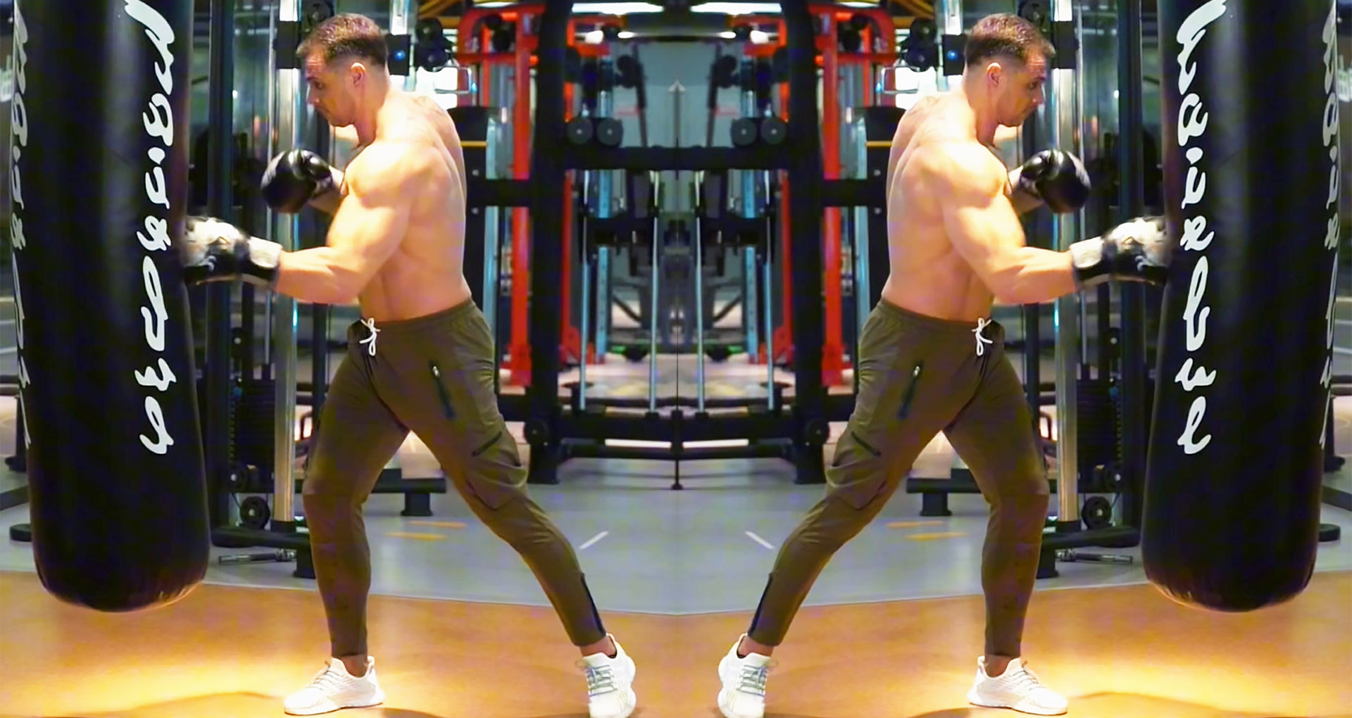 ANVTT Gym Apparel: Muscular Male Wearing ANVTT Athletic Pants Hitting Punching Bag