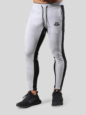 Man wearing ANVTT heather grey side stripe tapered jogger pants