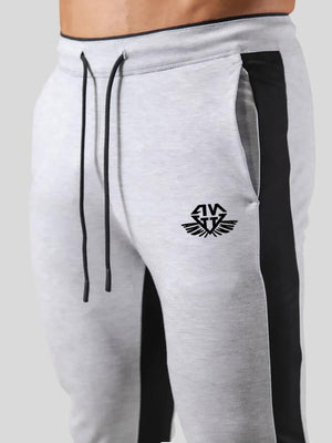 Man wearing ANVTT heather grey side stripe tapered jogger pants